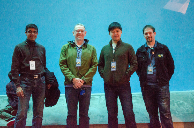 SPK team members pose in front of aquarium tank